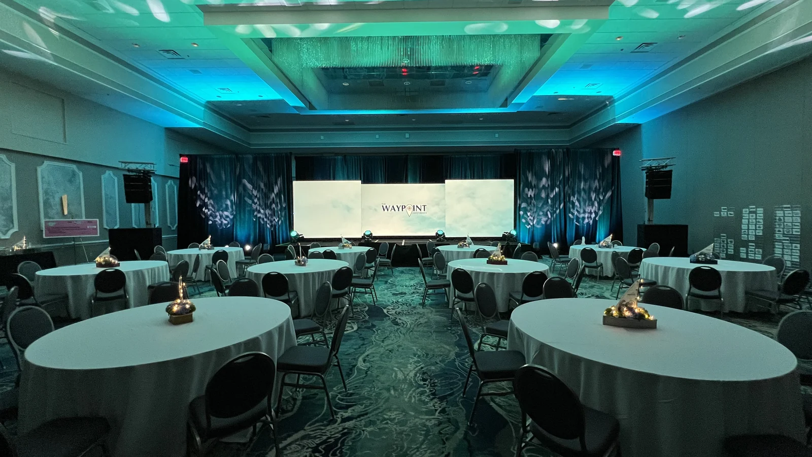 The finished ballroom on show day with LED walls and uplighting