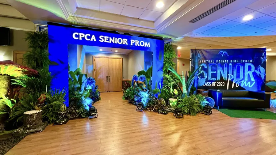 Celebration venue with blue uplighting and staging