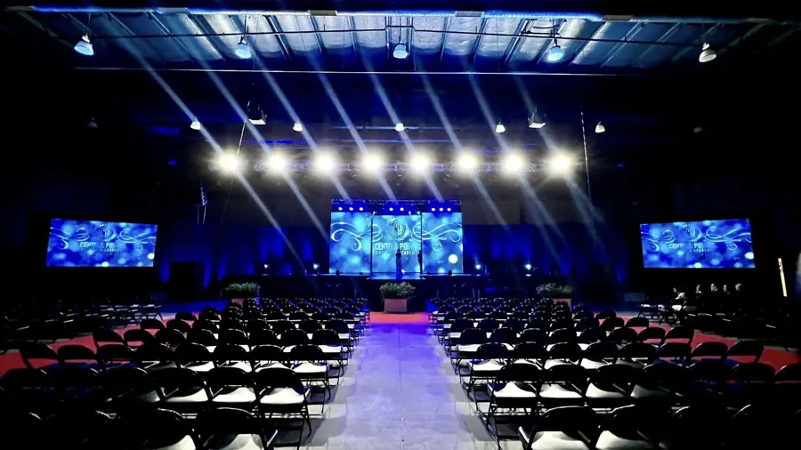 Corporate general session with LED screens and stage lighting