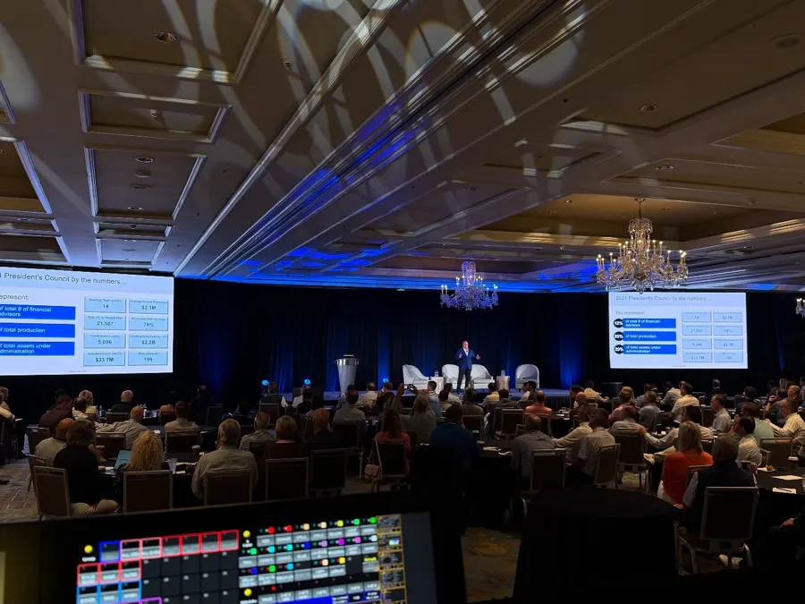 Ballroom event with stage lighting and guests
